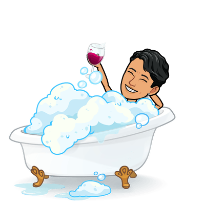 A person enjoying a glass of wine in a bubble bath.